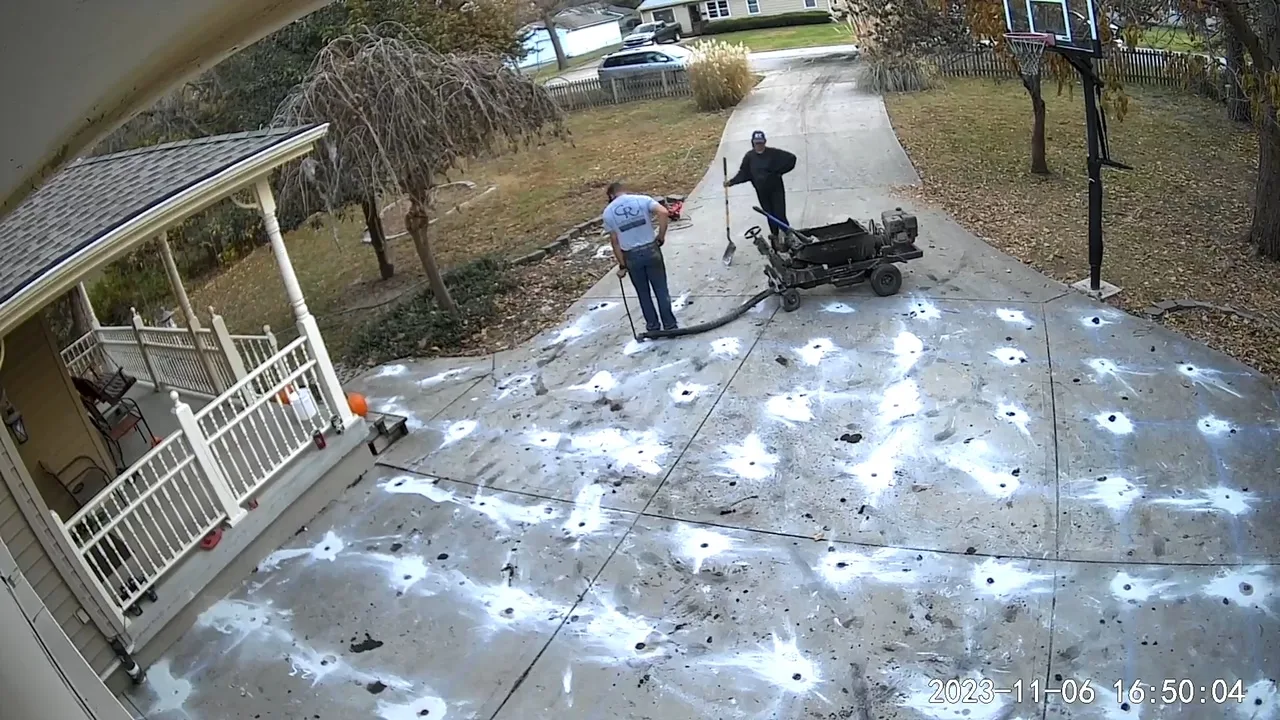 Concrete Rescue crew leveling a residential driveway with mudjacking equipment
